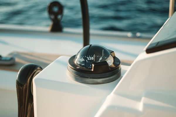 a compass mounted on a boat in the ocean